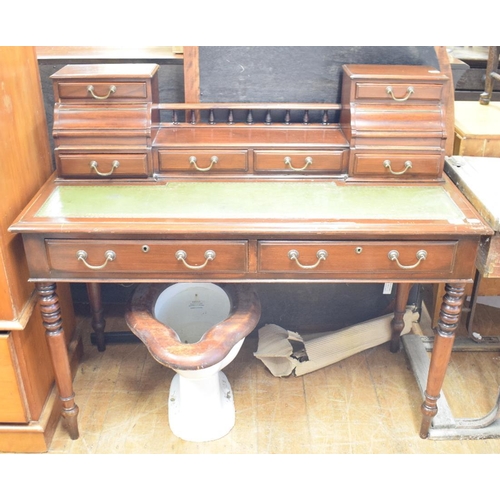 1141 - A mahogany desk, having a superstructure and a pair of freeze drawers, on turned legs, 123 cm wide