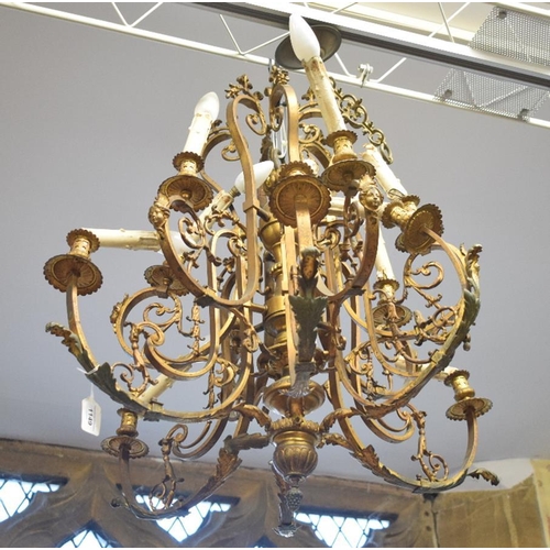 1149 - A gilt brass twelve light chandelier, fitted for electricity (needs re-wiring), 74 cm wide