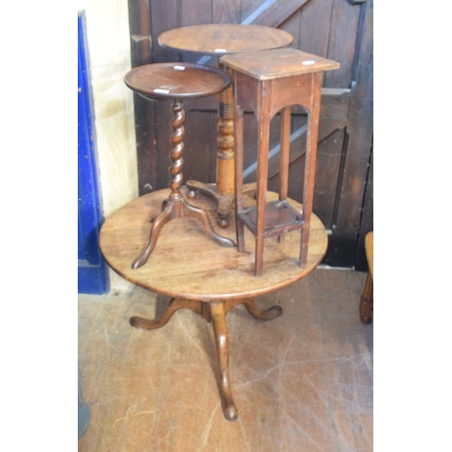 1160 - An oak low tripod table, 77 cm diameter, two wine tables and a jardiniere stand (4)