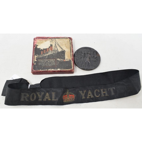 216 - A Lusitania medallion, boxed, and an early 20th century Royal Yacht cap tally (2)