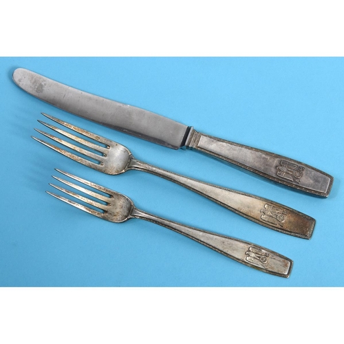 223 - An Adolf Hitler formal pattern silver coloured metal table knife, with a steel blade, with a matchin... 