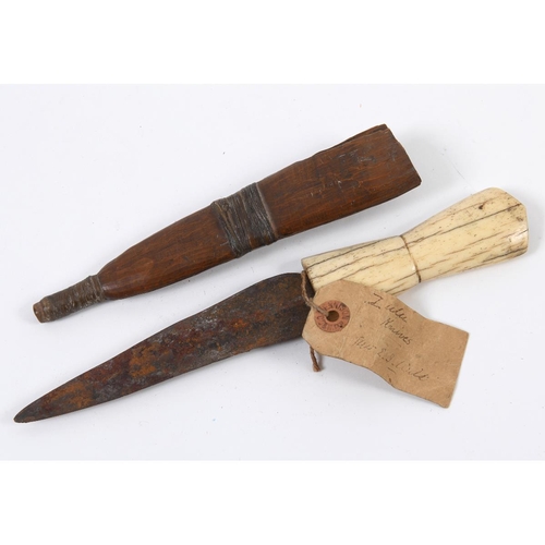 228 - A late 19th century Zulu knife, with a bone handle and wooden scabbard, with an old paper label 'Zul... 