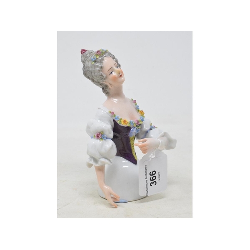 366 - A Muller porcelain half doll, lady with grey hair, wearing a purple and white dress with garlands of... 