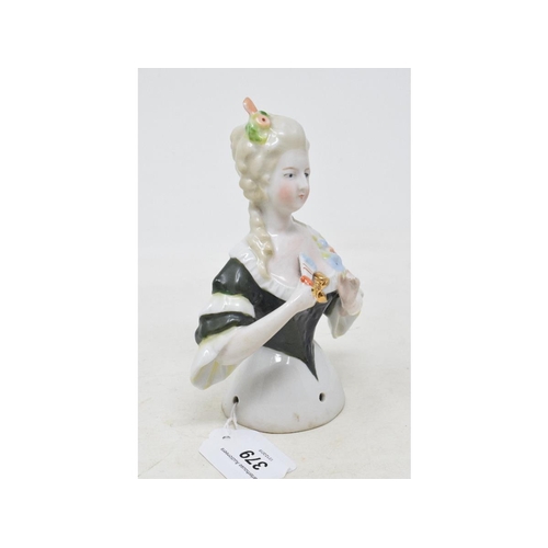 379 - A porcelain half doll, lady wearing a dark green dress, holding a fan, 15 cm high