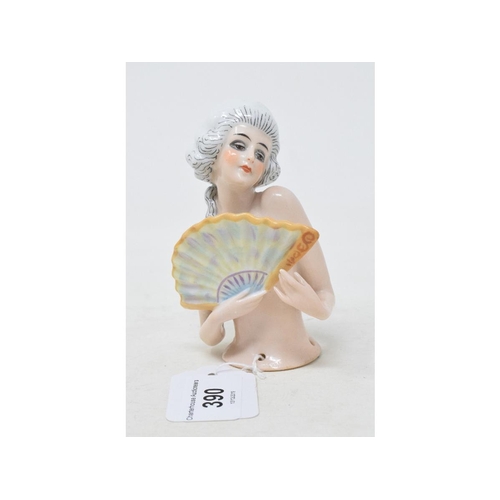 390 - A porcelain half doll, lady with white hair holding a fan, impressed no. 6903 to back, 10.5 cm high