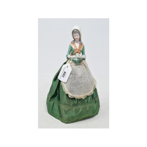 398 - A Galluba & Hoffman porcelain half doll, the chocolatier lady, wearing a green fabric dress, 25 cm h... 