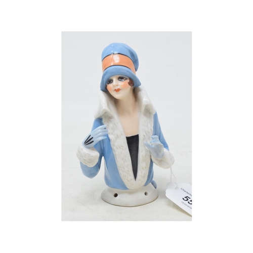 557 - An Art Deco porcelain half doll, lady wearing a blue fur lined coat and matching hat, impressed no. ... 