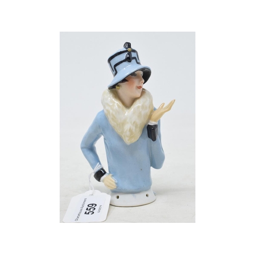 559 - An Art Deco porcelain half doll, 1920's fashion model, wearing a blue fur lined coat and matching ha... 