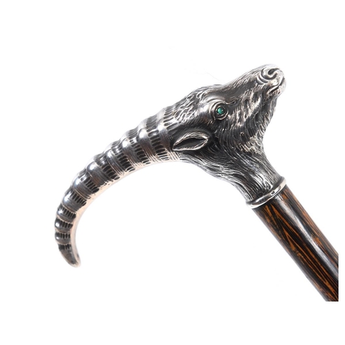 665 - A walking cane, the silver coloured metal handle in the form of an antelope or oryx head, with green... 