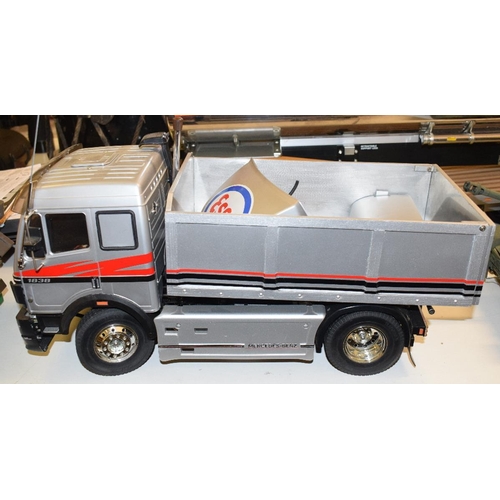 671 - A Mercedes-Benz tipper lorry, 1838, a Tamiya semi-trailer, and Esso petrol tanker (the wheels for th... 