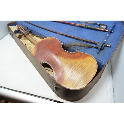 637 - A violin, having a two piece 36 cm back, with two bows, cased