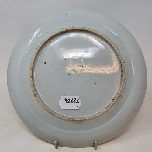 261 - A pair of Chinese porcelain plates, decorated dragons chasing flaming pearls, flowers and foliage, a... 