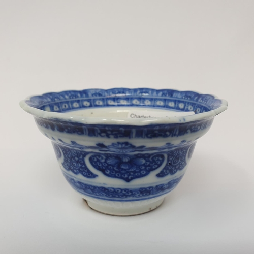 263 - An 18th century Chinese blue and white tea bowl, with scalloped border with hand painted and moulded... 