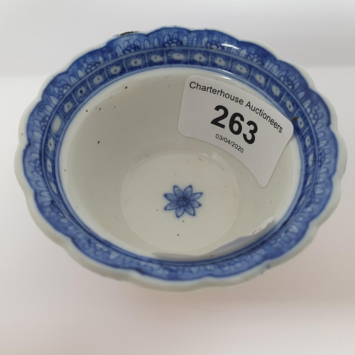 263 - An 18th century Chinese blue and white tea bowl, with scalloped border with hand painted and moulded... 