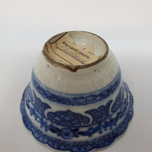 263 - An 18th century Chinese blue and white tea bowl, with scalloped border with hand painted and moulded... 