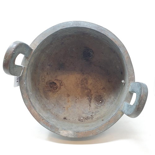 284 - A Chinese bronze censer, with twin handles, decorated clouds and other motifs, on three legs, 27 cm ... 