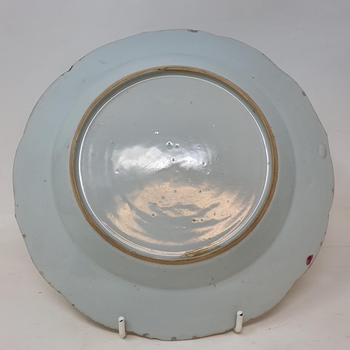 292 - A set of four Chinese porcelain famille rose plates, of shaped circular form, decorated flowers and ... 