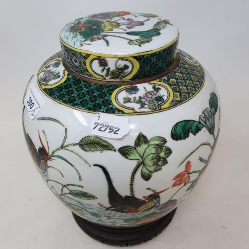 300 - A pair of Chinese famille verte ginger jars and covers, decorated birds, flowers and foliage, 21.5 c... 