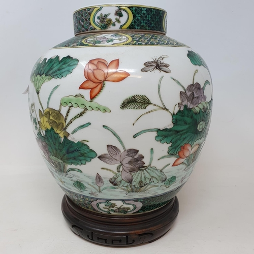 300 - A pair of Chinese famille verte ginger jars and covers, decorated birds, flowers and foliage, 21.5 c... 