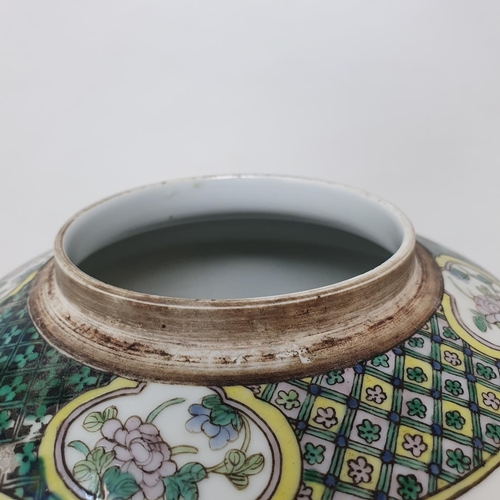 300 - A pair of Chinese famille verte ginger jars and covers, decorated birds, flowers and foliage, 21.5 c... 