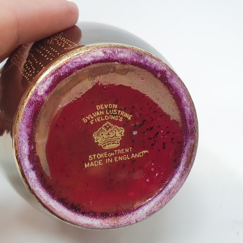 35 - A pair of Devon Fieldings Sylvan Lustrine bottle vases decorated with butterflies on a deep red lust... 