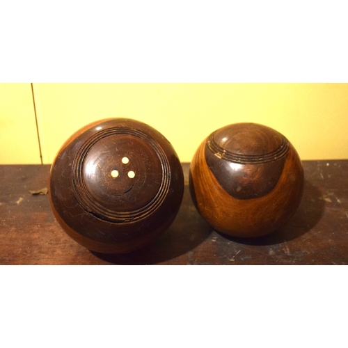 40 - Nine lignum vitae lawn bowls, in a pine box, 48.5 cm wide, removal cost A