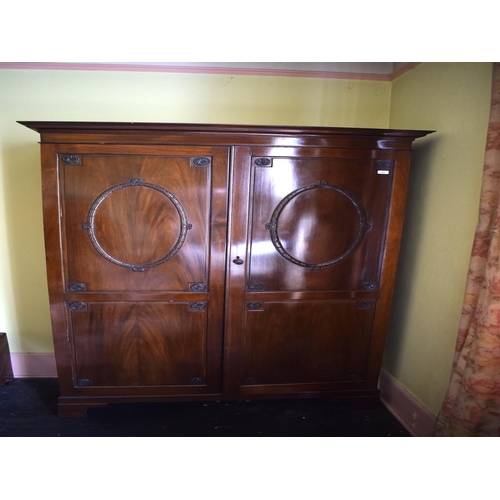 65 - A George III style mahogany two door wardrobe, carved leaves and rosettes, 132 cm wide, removal cost... 