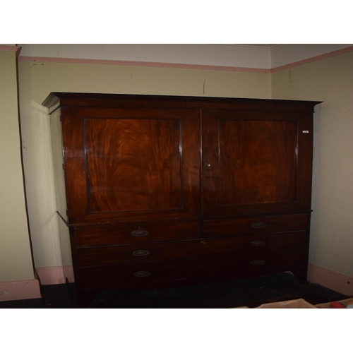 125 - A 19th century mahogany linen press, having a pair of panel doors above two short and two graduated ... 