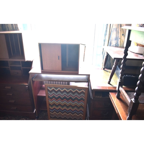 135 - A reproduction mahogany desk, top left drawer in pieces, 137 cm wide, a torchere, a bookcase, and ot... 