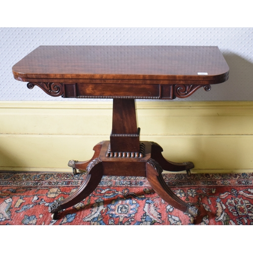 157 - A Regency mahogany D shaped card table, on a tapering column with four reeded downswept legs, 91 cm ... 