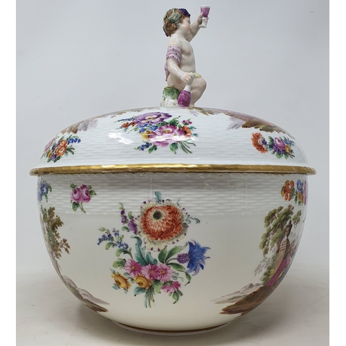 179 - A Berlin porcelain punch bowl and cover, with a putto finial, decorated extensive scenes of figures ... 