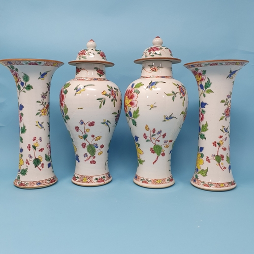 185 - A Chinese famille rose garniture of four vases, decorated flowering shrubs and exotic birds, compris... 