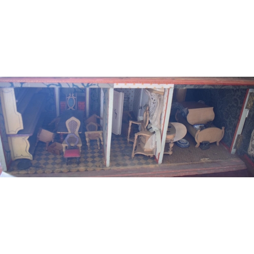 121 - A late 19th/early 20th century three storey doll's house, No 5, with a large group of assorted furni... 