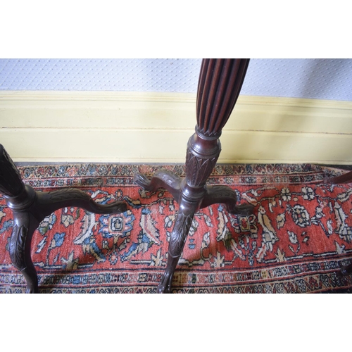 160 - A pair of mahogany torcheres, with baluster reeded columns and leaf carved legs with claw and ball f... 