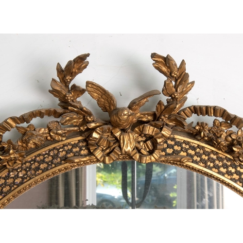 201 - A large pair of 19th century gilt gesso oval overmantel mirrors, each surmounted with a bird, a ribb... 