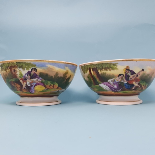 242 - A pair of late 19th century porcelain bowls, decorated figures and dwellings, 20.5 cm diameter (2), ... 