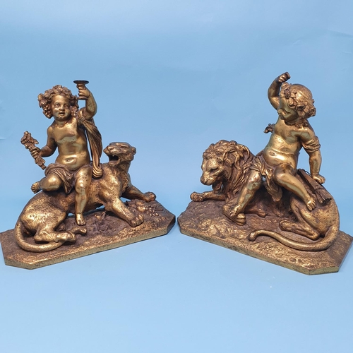 244 - A pair of ormolu groups, with cherubs seated upon a lion and lioness, one cherub wing detached, 22 c... 