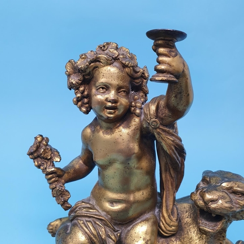 244 - A pair of ormolu groups, with cherubs seated upon a lion and lioness, one cherub wing detached, 22 c... 