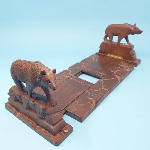 252 - An early 20th century Black Forest book trough, carved bears, 35 cm wide, removal cost A