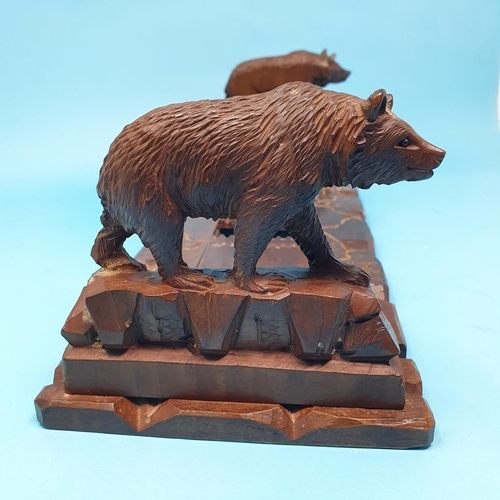 252 - An early 20th century Black Forest book trough, carved bears, 35 cm wide, removal cost A