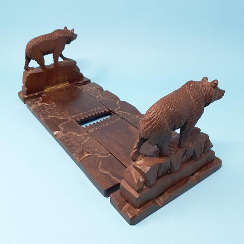 252 - An early 20th century Black Forest book trough, carved bears, 35 cm wide, removal cost A