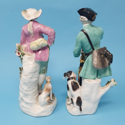 255 - A 19th century porcelain figure, of a hunter with a rifle, 18 cm high, and another Dresden figure of... 