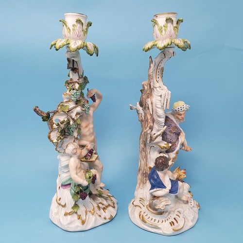 258 - A pair of Dresden candlesticks, autumn and winter, figural bases, 30 cm high, removal cost A