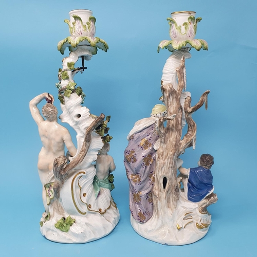 258 - A pair of Dresden candlesticks, autumn and winter, figural bases, 30 cm high, removal cost A