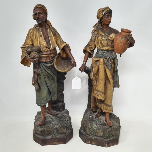 26 - A pair of earthenware Moorish type figures, the water carrier and the fruit carrier, slight damage, ... 