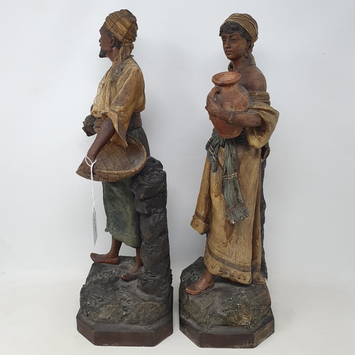 26 - A pair of earthenware Moorish type figures, the water carrier and the fruit carrier, slight damage, ... 