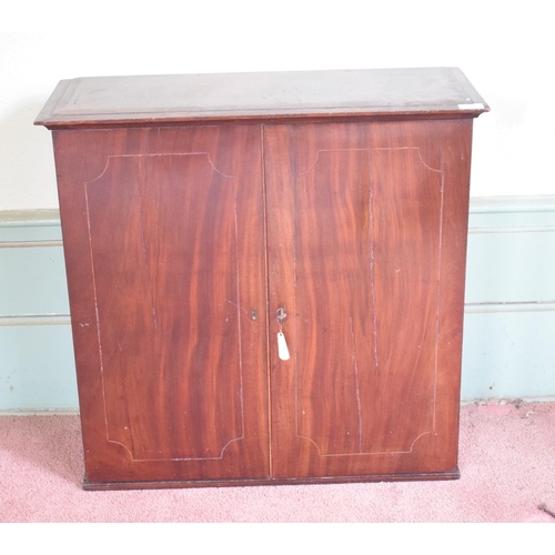 261 - A 19th century mahogany cabinet, having a pair of doors enclosing pigeon holes named A-Z, and with t... 