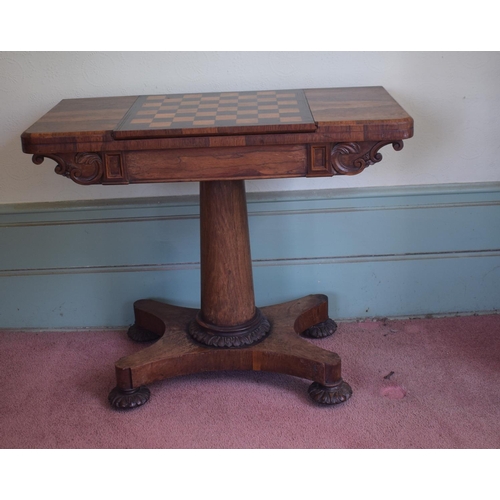 276 - An early Victorian rosewood games table, with reversible central section, on a tapering column, with... 