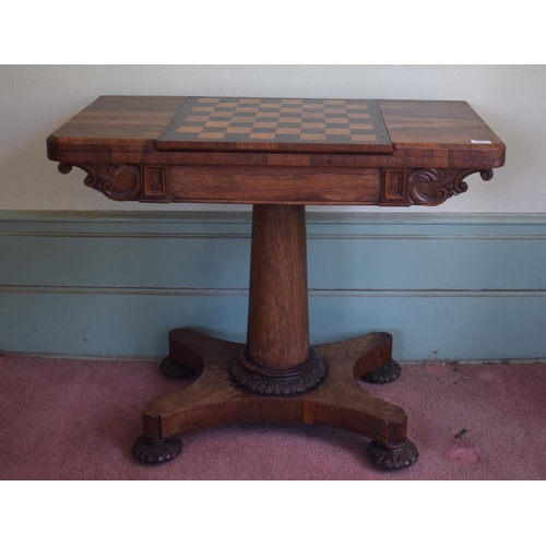 276 - An early Victorian rosewood games table, with reversible central section, on a tapering column, with... 