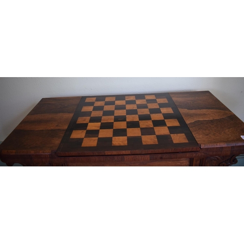 276 - An early Victorian rosewood games table, with reversible central section, on a tapering column, with... 